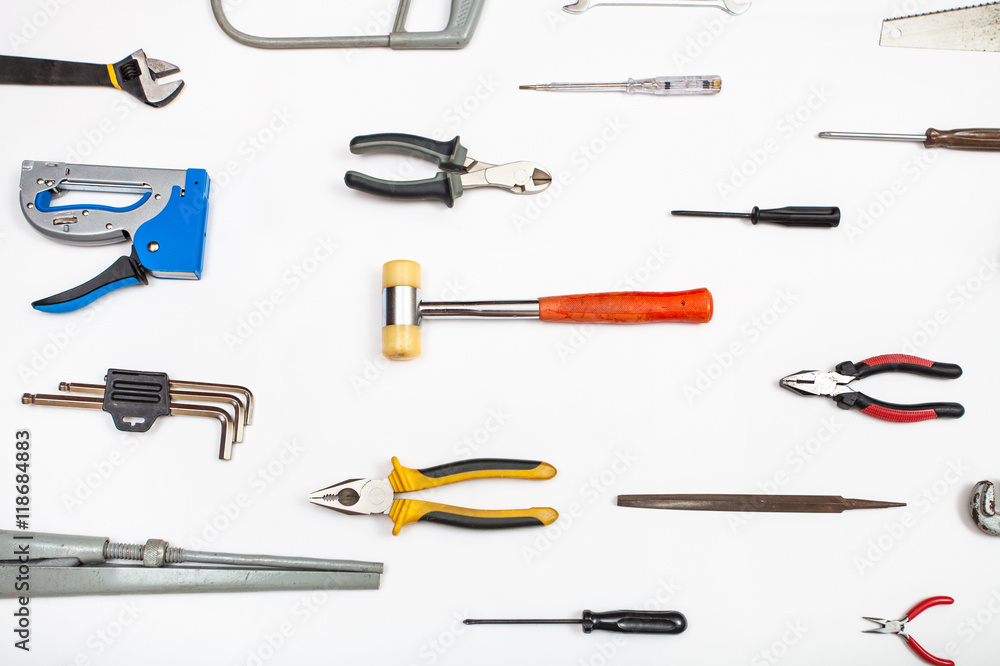 various hand tools arranged on white