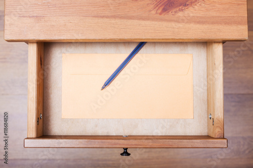 modern pen and envelope in open drawer