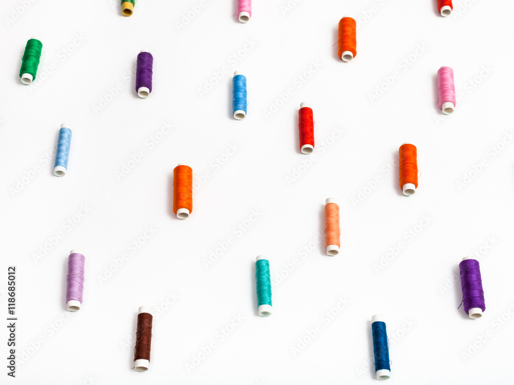 side view of many spools of sewing thread side view of many spools of sewing thread