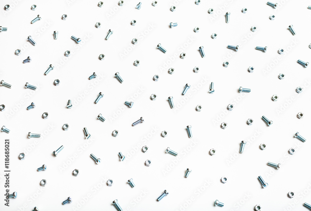 above view of many steel bolts and nuts on white