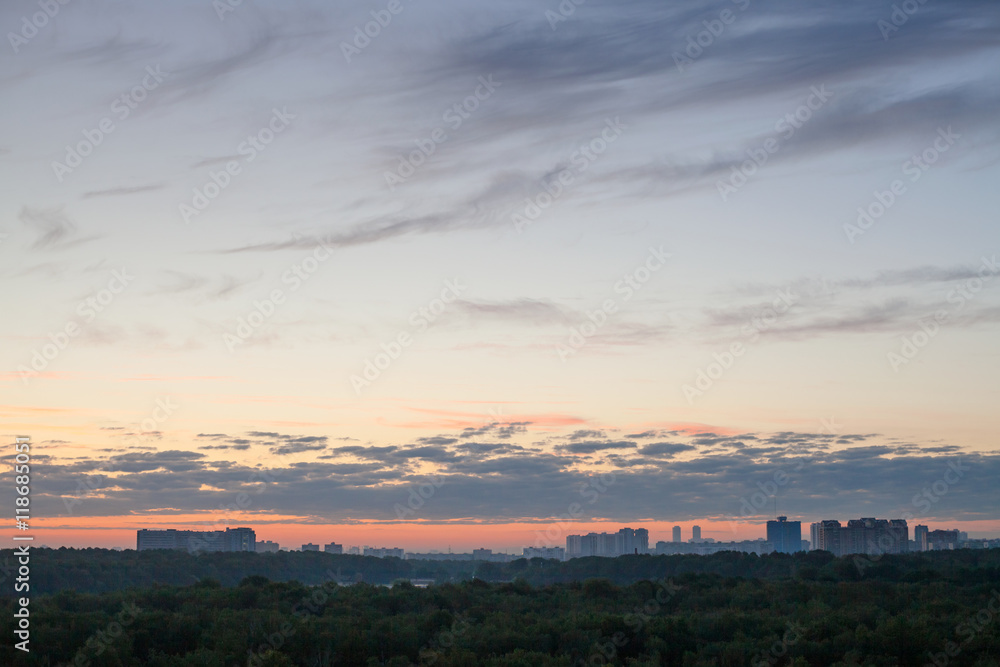 blue sky with pink horizon over city