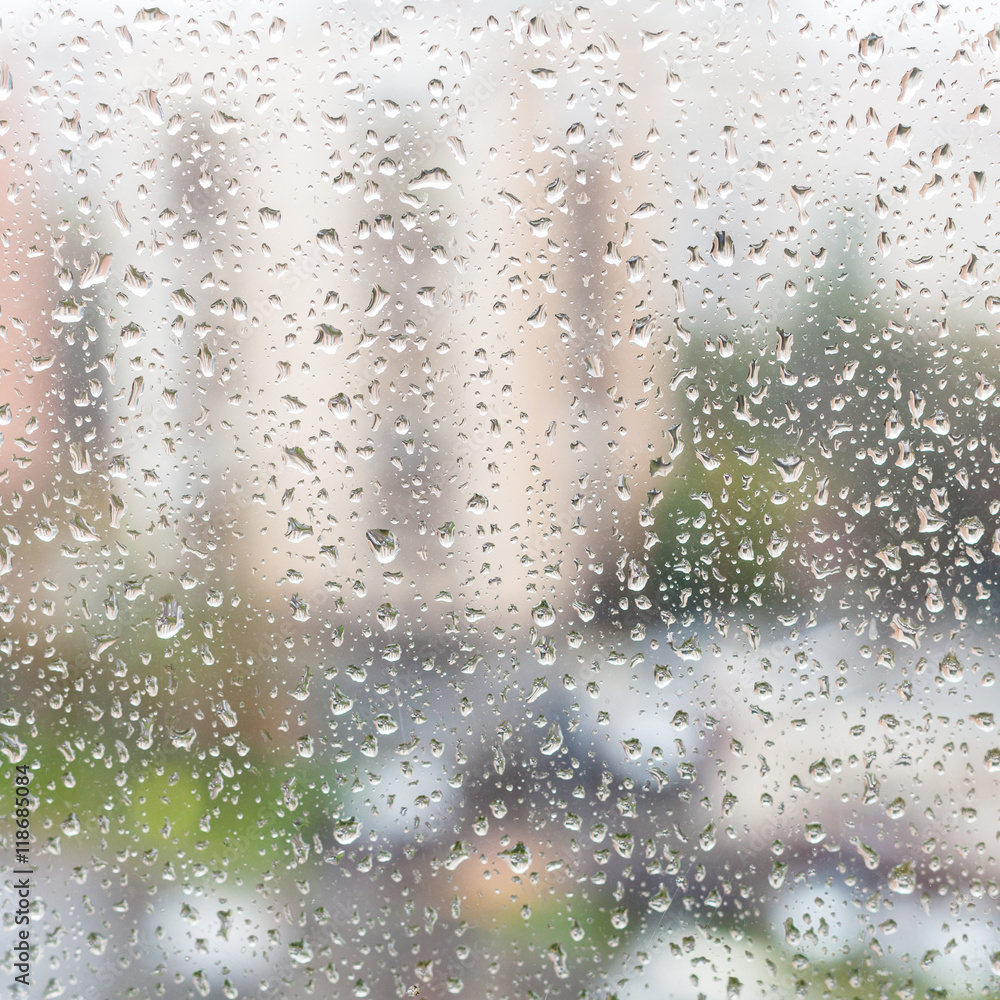 rain drops on window glass of apartment house