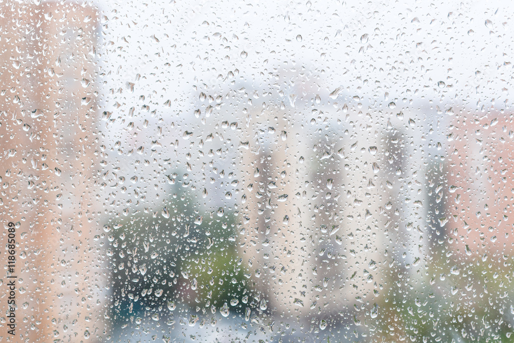 view of raindrops on window glass of urban house view of raindrops on window glass of urban house