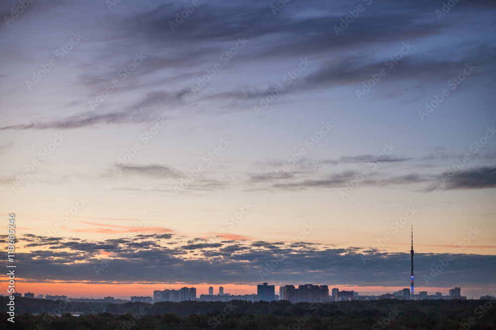 dark blue sky with pink horizon over city at dawn