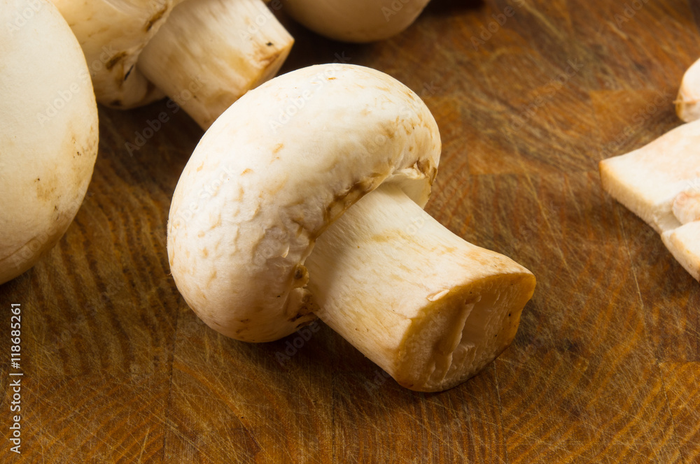 champignons on wooden background champignons on wooden background