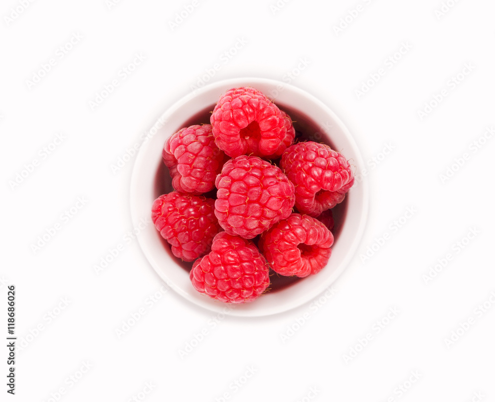 Raspberries in a white ceramic bowl isolated on white background Raspberries in a white ceramic bowl isolated on white background