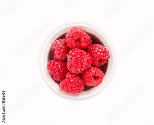 Raspberries in a white ceramic bowl isolated on white background