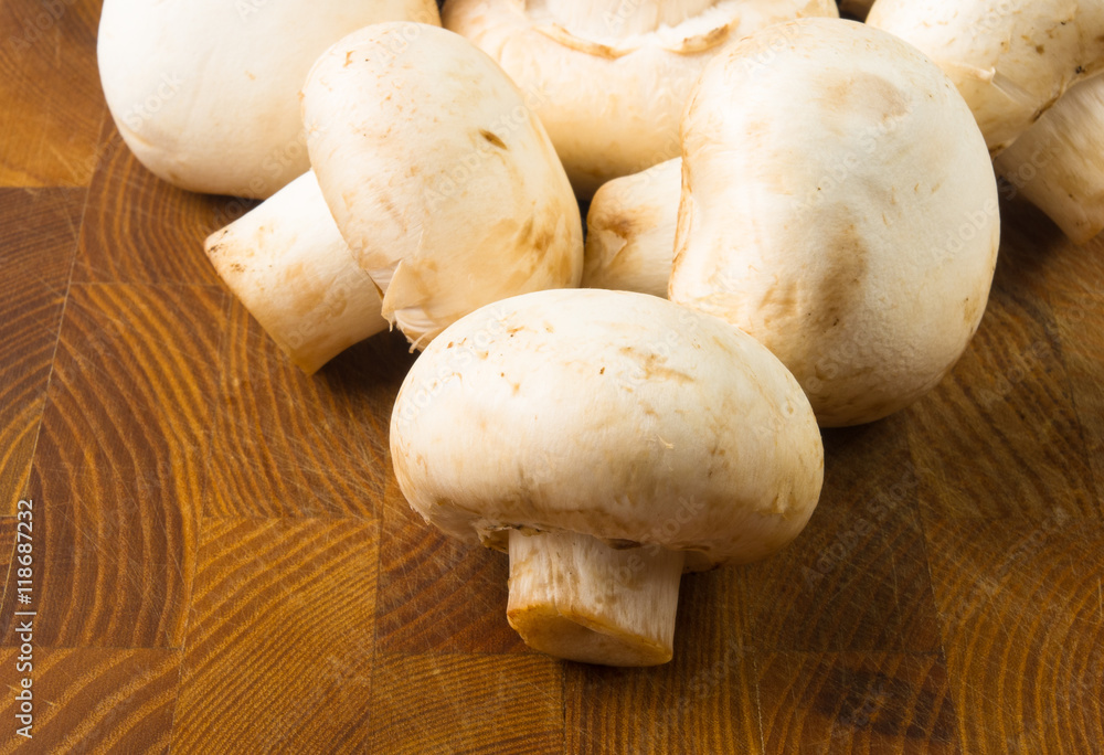 champignons on wooden background champignons on wooden background