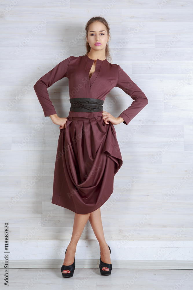 Portrait of beautiful girl in dress chocolate brown in the Studio Portrait of beautiful girl in dress chocolate brown in the Studio