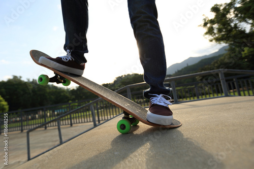 young woman skateboarding at skatepark © lzf