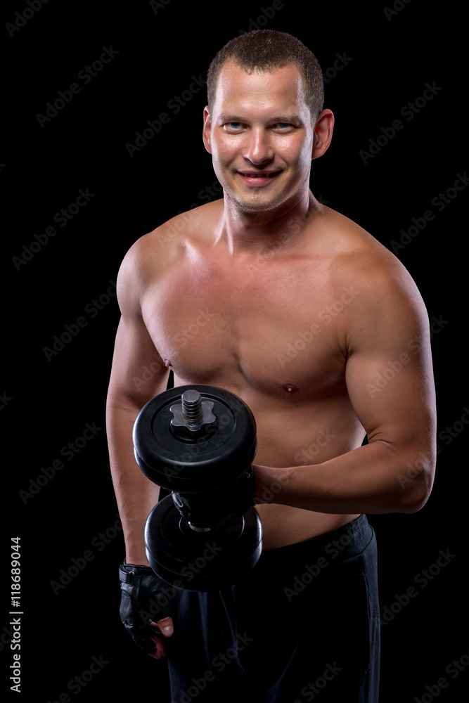 Happy bodybuilder with dumbbell and naked torso Happy bodybuilder with dumbbell and naked torso