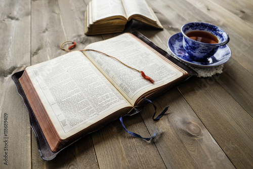 Bibles and cup of tea on wood table. Non TM Bibles.