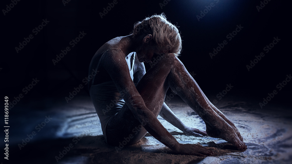 Fototapeta premium Portrait of beautiful woman lying on the floor with flour