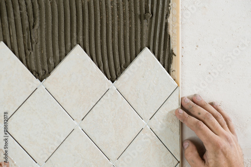 laying tile, hand of the master close-up
