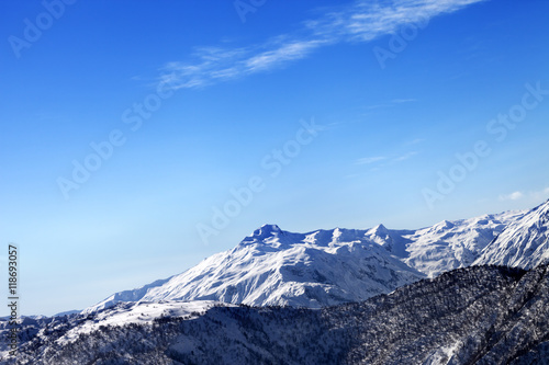 Snowy mountains and blue sky in early sunny morning
