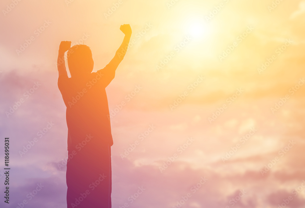Silhouette of woman praying over beautiful sky background Silhouette of woman praying over beautiful sky background
