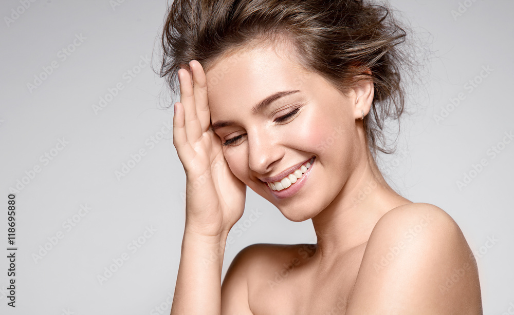 Beautiful smiling woman with natural make-up, clean skin and white teeth on grey background - obrazy, fototapety, plakaty 