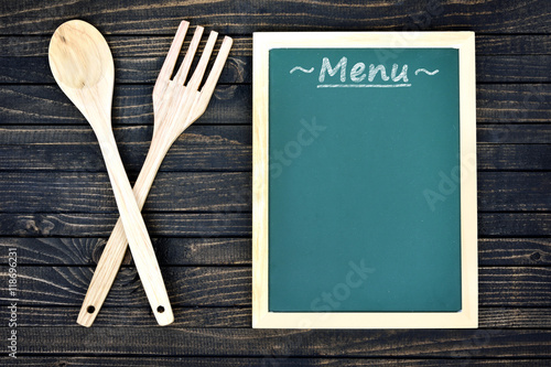 Kitchen utensils and menu  on table
