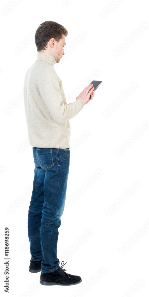 back view of business man uses mobile phone. rear view people collection. Isolated over white background. backside view of person. Curly short-haired man in a woolen white jacket standing sideways back view of business man uses mobile phone. rear view people collection. Isolated over white background. backside view of person. Curly short-haired man in a woolen white jacket standing sideways