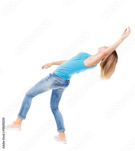 Balancing young woman. or dodge falling woman. Rear view people collection. backside view of person. Isolated over white background. The blonde in a blue shirt and jeans during the fall.
