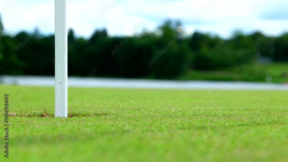Close up shot of a hall and white golf ball that goes directly to the
