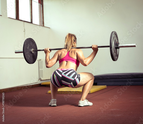 Girl doing squats with weight