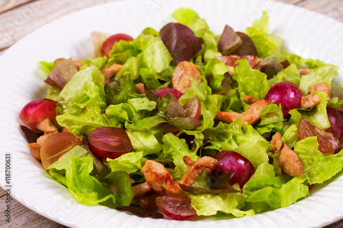 Chicken and red grape salad in white plate.