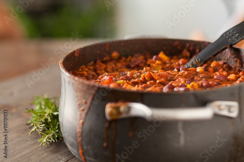 Organic Vegetarian Chili In Iron Pot Served With Rosemary On Dis