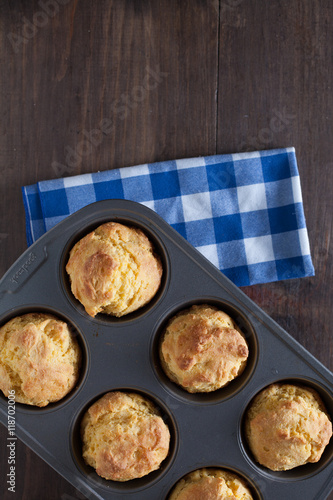 Corn Bread Muffins In Muffin Pan On Country Distressed Wood Tabl