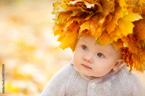 Little boy in autumn orange leaves. Outdoor.