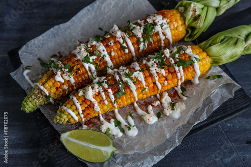 Elote or Mexican grilled corn on the cob served with cotija cheese and chili powder.