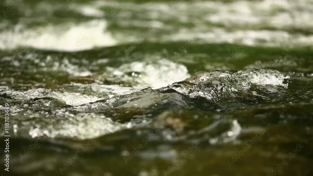 Splashes of water rolling on a mountain river Splashes of water rolling on a mountain river
