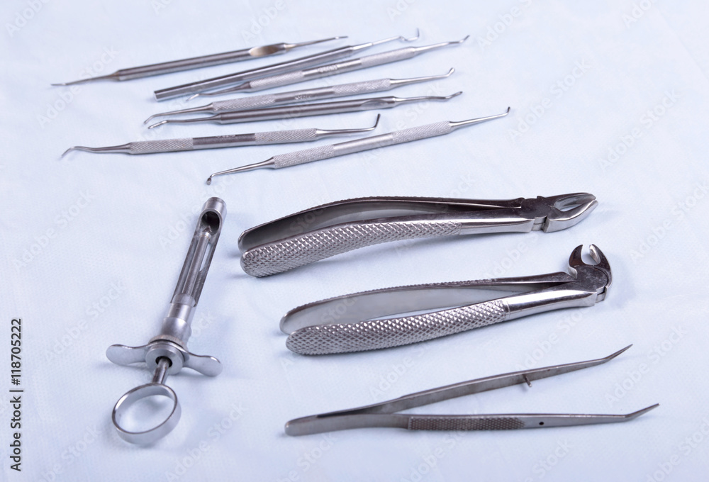 Medical instruments for dentists on blue table Medical instruments for dentists on blue table