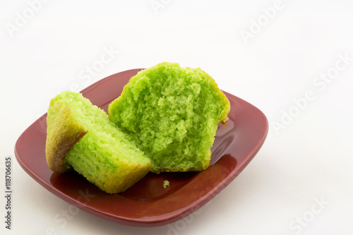 Green pistachio nut muffin on red plate