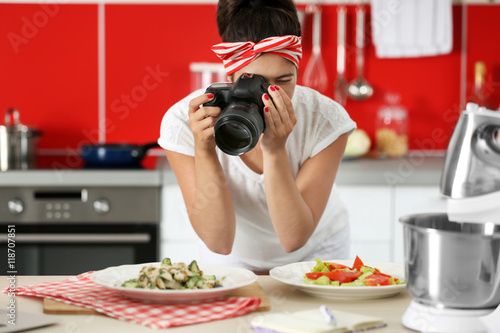 Girl photographing on kitchen. Food blogger concept