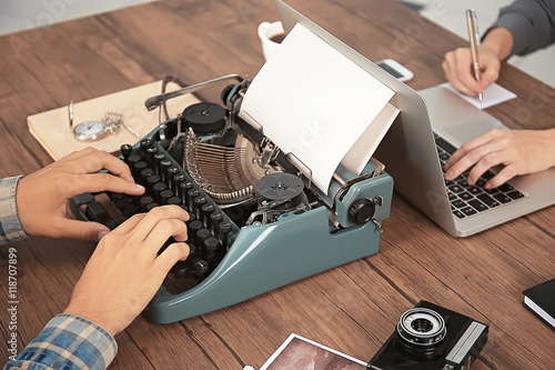 Old typewriter and laptop, concept of technology progress