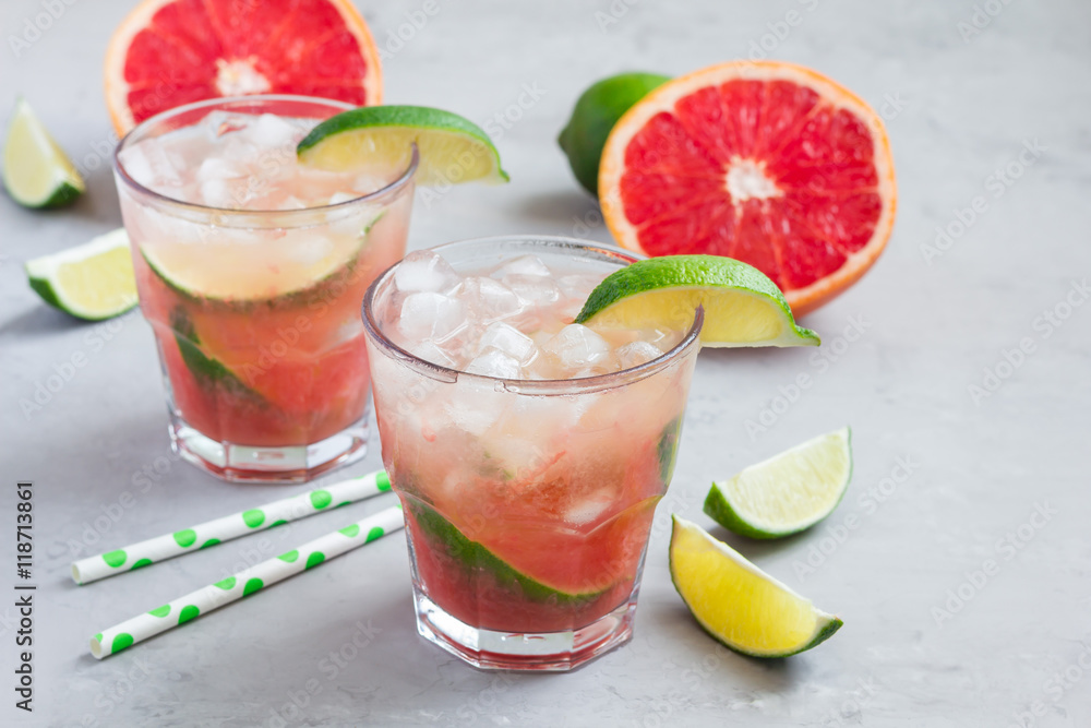 Cold pink cocktail with fresh grapefruit, lime, copy space Cold pink cocktail with fresh grapefruit, lime, copy space