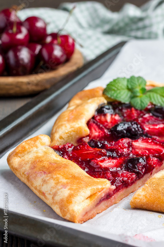 Cottage cheese dough galette with strawberry and cherry, vertical