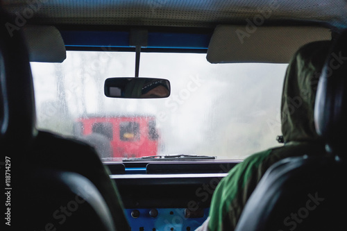 Adventure off road car in rainy hazy environment, view from inside car, selective focus