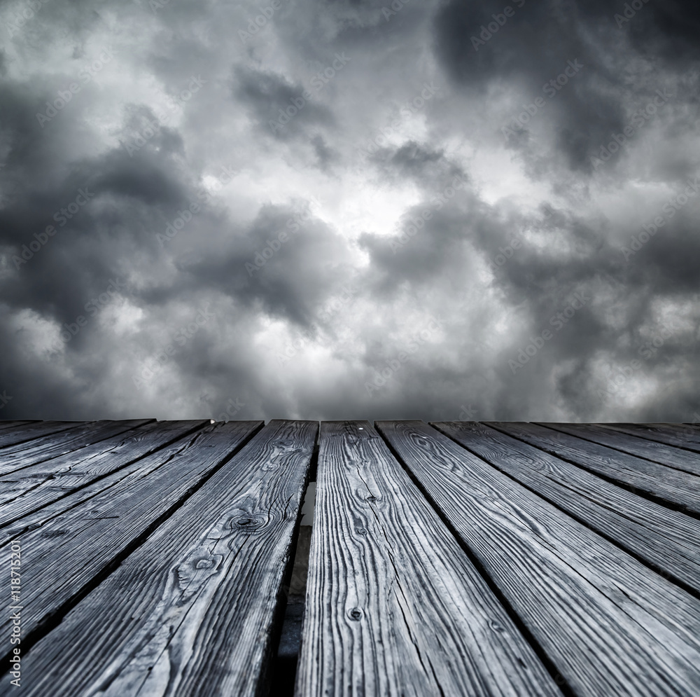 Rostrum made of wooden planks on stormy sky Rostrum made of wooden planks on stormy sky