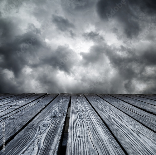 Rostrum made of wooden planks on stormy sky