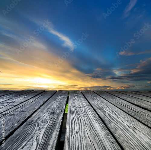 Fototapeta Naklejka Na Ścianę i Meble -  Rostrum made of wooden planks on sunset