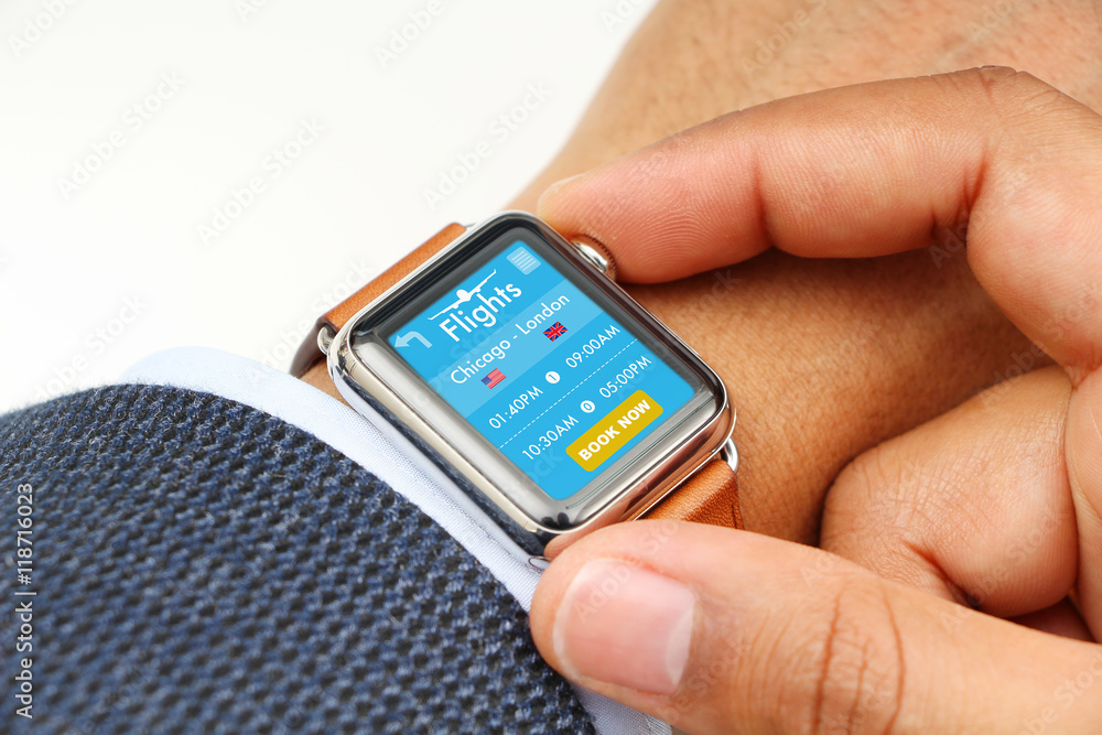 Businessman buying airplane ticket through a smart watch app Businessman buying airplane ticket through a smart watch app