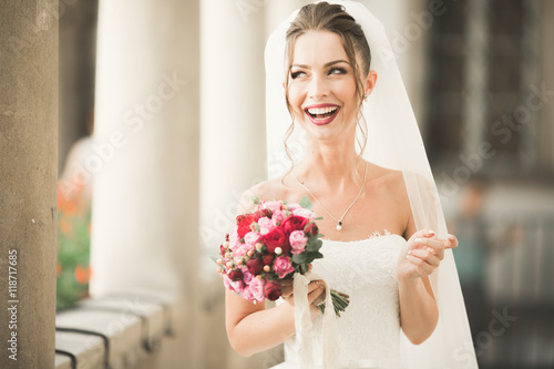 Luxury wedding bride, girl posing and smiling with bouquet