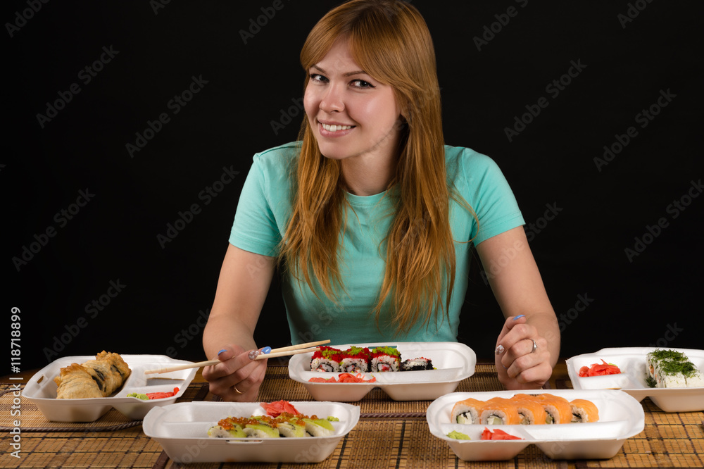 attractive smiling woman sitting at the table with rolls attractive smiling woman sitting at the table with rolls