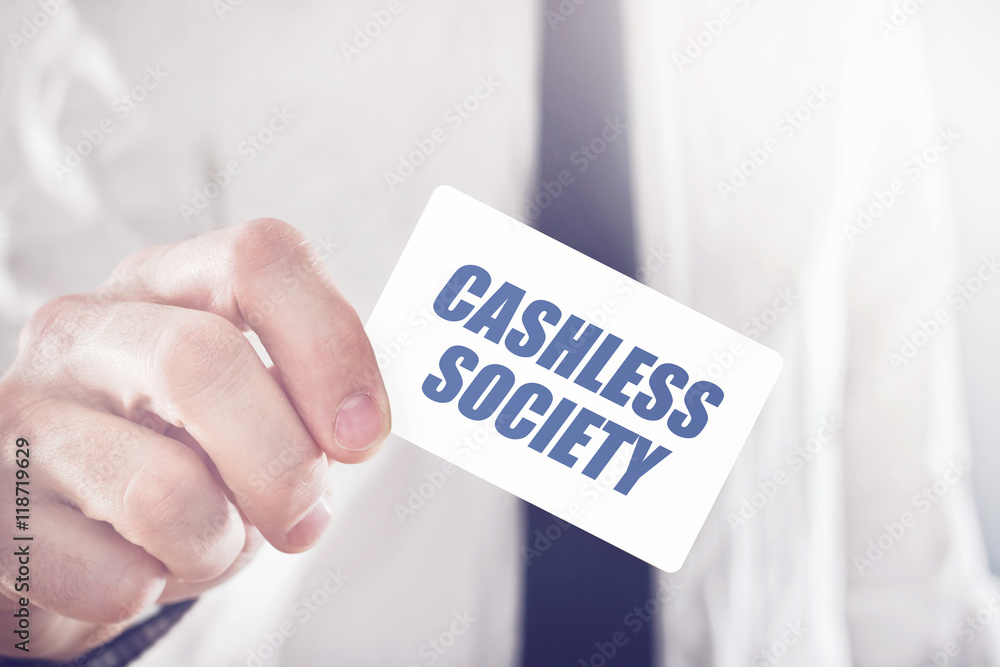Businessman holding card with Cashless society title Businessman holding card with Cashless society title