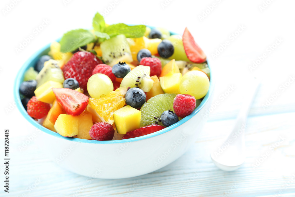 Fresh fruit salad on a white wooden table Fresh fruit salad on a white wooden table