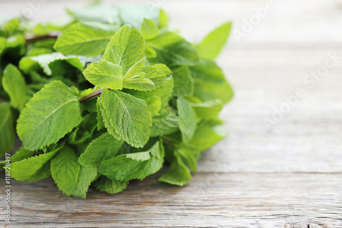 Fresh mint leafs on grey wooden table