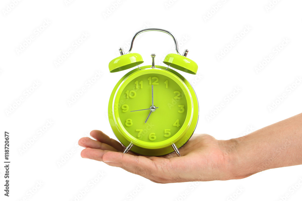 Male hand holding green alarm clock on white background Male hand holding green alarm clock on white background