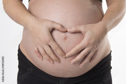Pregnant Woman holding her hands on beautiful belly